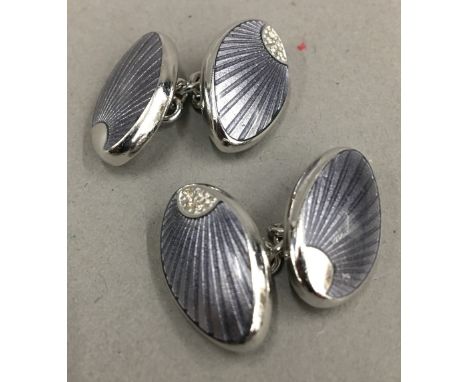 A pair of silver and enamel cufflinks