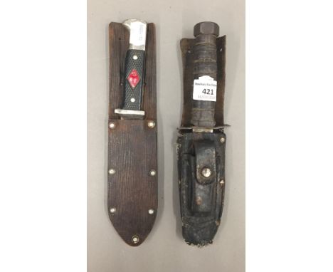 A vintage American Commando knife in leather sheath, together with an early Scout's Solingen knife and scabbard
