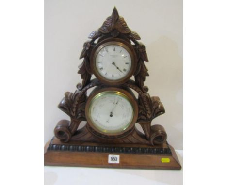 EDWARDIAN CLOCK BAROMETER, in foliate carved mahogany table top casing by Searle &amp; Co. 41cm height 