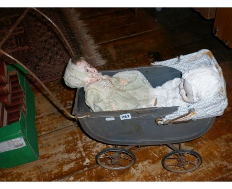 A bisque headed open mouthed doll impressed mark for Porzellanfabrik-Burggrub no. 169. Together with a vintage tinplate toy d