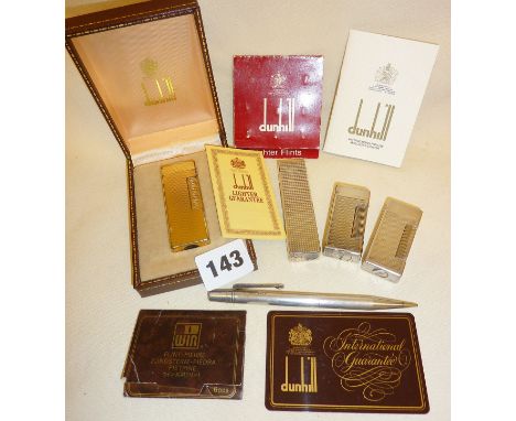 Gold plated Dunhill Rollagas lighter in case, two other Dunhill mini Rollalite lighters, a hallmarked silver mechanical penci