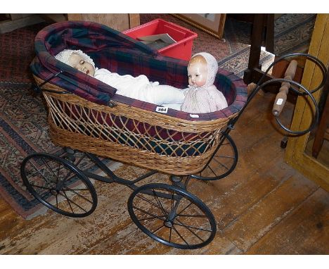 Vintage wickerwork child's dolls carriage on four wheels with hood and lined with tartan fabric. Together with a vintage comp