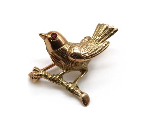 A 9ct gold bird brooch, possibly a sparrow with a ruby set eye, to pin and roller catch, London 2006, 25mm wide, 2.88gConditi