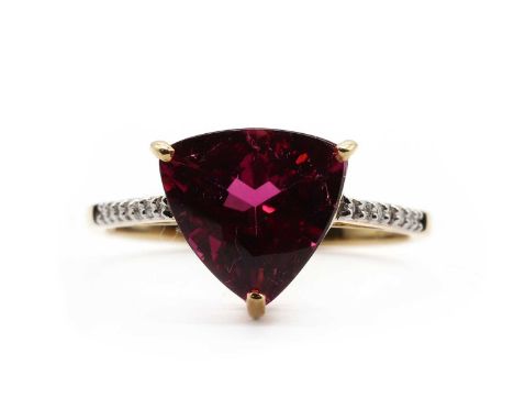 An 18ct gold rubellite tourmaline and diamond ring,a triangular mixed cut rubellite tourmaline, approximately 9.50mm, claw se