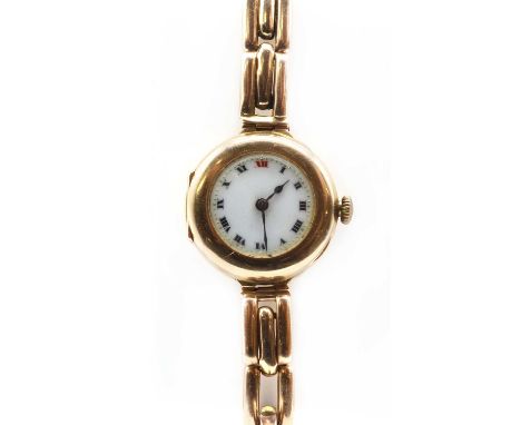 A ladies' 15ct gold pin set mechanical bracelet watch,a white enamel dial with black Roman numerals with red at '12', and blu