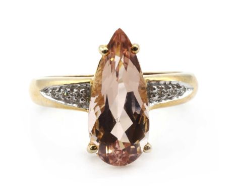 A 9ct gold morganite and diamond ring,a pear mixed cut morganite, approximately 15.70 x 7.00mm, claw set, to shoulders grain 