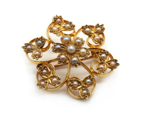 An Edwardian gold split pearl flower brooch/pendant, with pin and 'C' catch, and concealed wire bale, tested as approximately