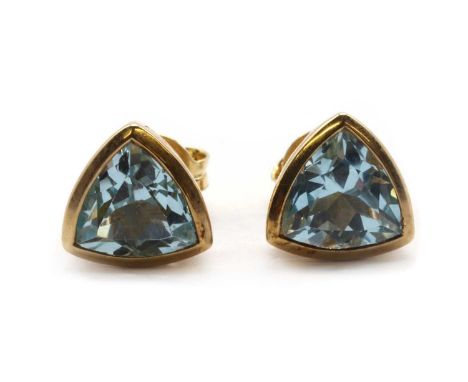 A pair of 9ct gold single stone blue topaz stud earrings,a triangular mixed cut blue topaz, approximately 7.50mm, rub set, to