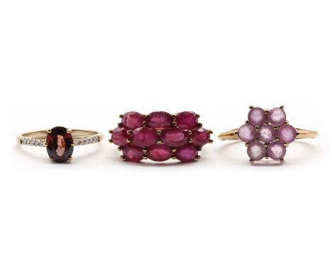 Three 9ct gold rings, comprising a pink sapphire cluster ring, Birmingham 2010, a fracture filled ruby cluster ring, Birmingh