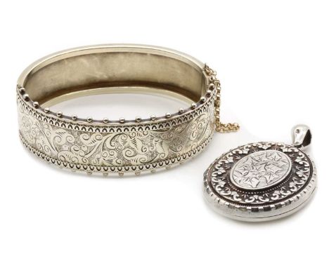 A Victorian sterling silver locket, with engraved ivy decoration, Birmingham 1882, together with a Victorian silver oval hing