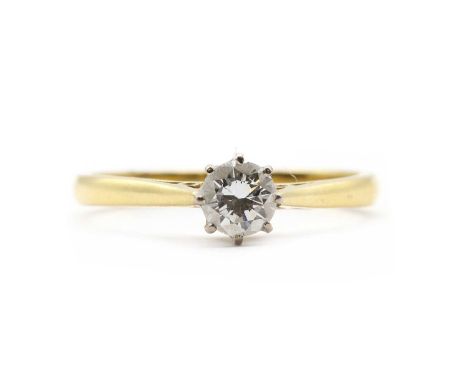 An 18ct gold single stone diamond ring,a round brilliant cut diamond, claw set to a white gold rex setting, to yellow gold ta