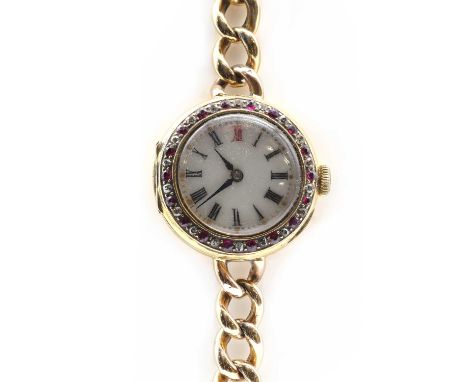 A ladies' gold ruby and diamond set mechanical bracelet watch, 27mm diameter with a white enamel dial with black Roman numera
