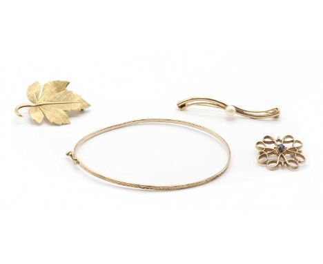 A small collection of gold jewellery, comprising a gold hollow wire bangle, tested as approximately 9ct gold, a gold sapphire