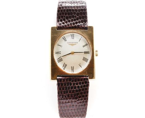 A 9ct gold Longines mechanical strap watch, a rectangular case, 29mm wide, with an oval silvered dial, black Roman numerals a