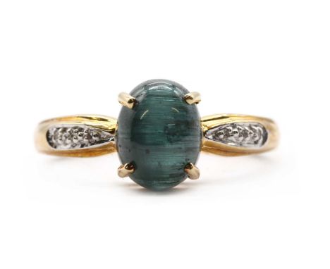 A 9ct gold cat's eye tourmaline and diamond ring,an oval cabochon cat's eye green tourmaline, claw set, to shoulders grain se