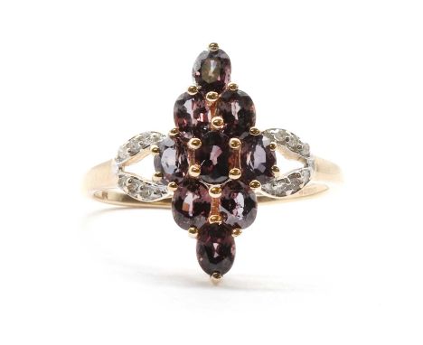 A 9ct gold gem and diamond set ring, a marquise or navette shaped cluster of oval mixed cut purple gemstones, possibly purple