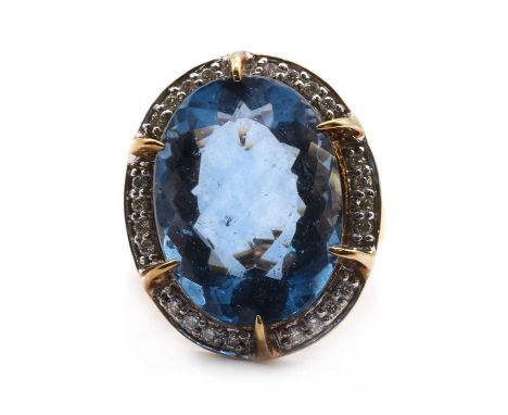 A 9ct gold colour change fluorite and diamond halo cluster ring,an oval mixed cut colour change fluorite, approximately 20 x 