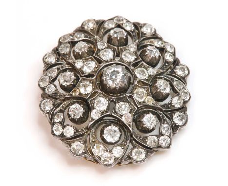 A Victorian diamond set oval cluster brooch/pendant, c.1880,with an old European cut diamond in a cut down collet at the cent