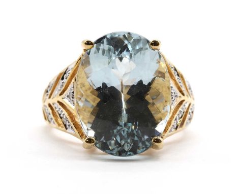 An 18ct gold aquamarine and diamond ring,an oval mixed cut aquamarine, approximately 16.30 x 12.40mm, claw set, to pierced ta