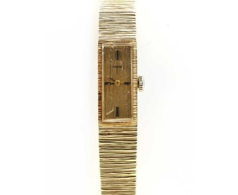 A ladies' 18ct gold Tewor mechanical bracelet watch, a rectangular case with a gilt textured dial and baton hour markers at t