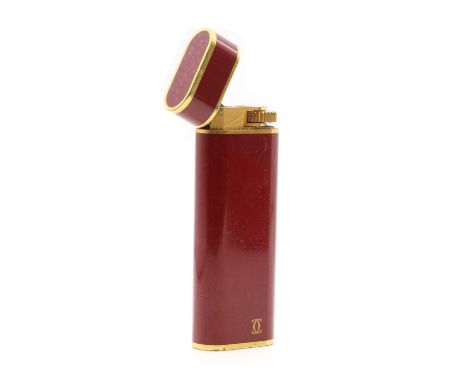 A Cartier lighter,of ovoid form, with red lacquered finish, no. 13030T, signed Cartier, Paris,together with a Cartier box,mar