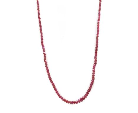 A single row graduated faceted ruby bead necklace, with gold jump ring and bolt ring, tested as approximately 9ct gold, 455mm