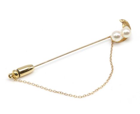 A two stone cultured pearl stick pin, by Mikimoto, c.1970,with a pair of 6.00 to 6.30mm cultured pearls, peg set to one end. 