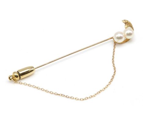 A two stone cultured pearl stick pin, by Mikimoto, c.1970,with a pair of 6.00 to 6.30mm cultured pearls, peg set to one end. 