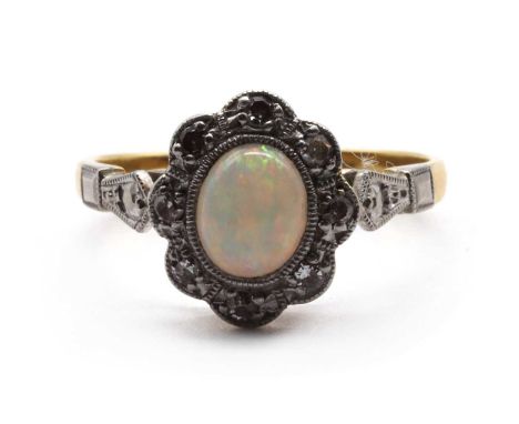 A gold opal and diamond cluster ring, an oval cabochon opal to surround of eight cut diamonds, grain set to a scalloped edge,