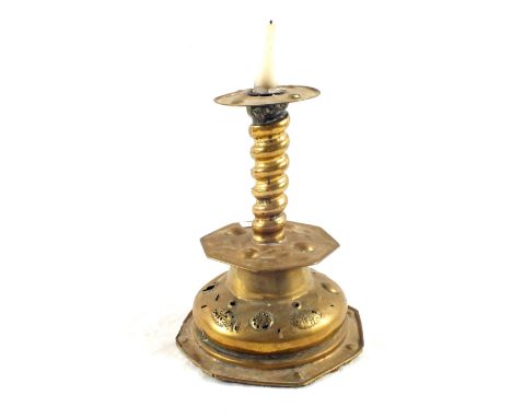 A 17th Century German Brass candlestick on wide pierced base, spiral column and embossed decoration, height 10"