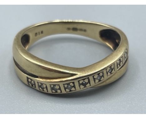 Ladies 9ct gold diamond crossover band. 2.18g size K