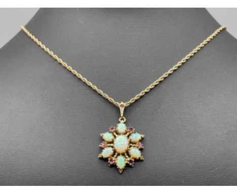 Ladies 9ct gold Opal and Garnet pendant and chain. Featuring opal set centre stone and 6 opals surrounding with garnets in be