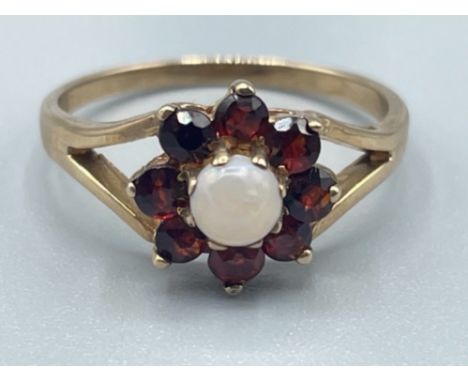 Ladies 9ct gold Garnet and opal cluster ring. Featuring a opal set and surrounded by 8 garnet stones. 2.2g size N