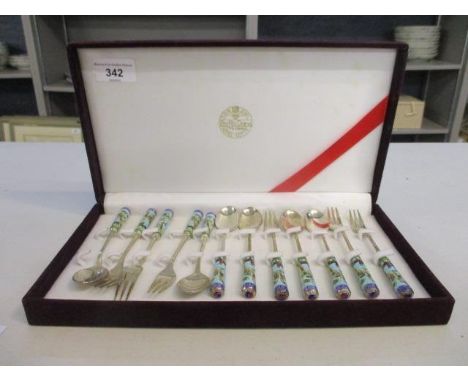 A cased set of white metal and enamel cutlery 