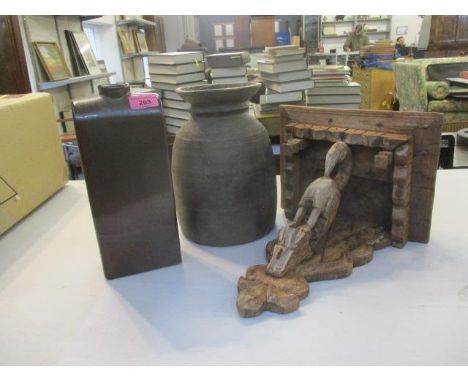 An aged wooden vase, a carved wooden wall bracket and a pottery vase 