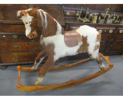 A rocking horse made from cow hide, 43" h x 62"w 