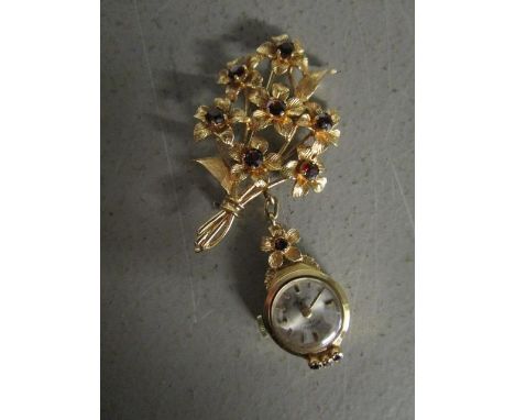 A 9ct yellow gold and garnet set floral spray brooch with matching pendant Rotary 21 jewel ladies watch, the 9ct gold case al