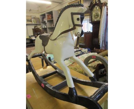 A small painted rocking horse, 34" x 22" and a smaller version 