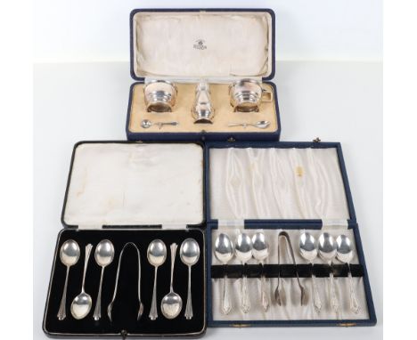 A silver cruet set, Mappin &amp; Webb, Birmingham 1935, of salt, pepper and mustard with blue glass liners, with two spoons, 