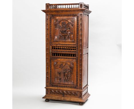 19TH CENTURY DUTCH CARVED OAK CUPBOARD
the galleried top with shelving below enclosed by a heavily carved panel door with two