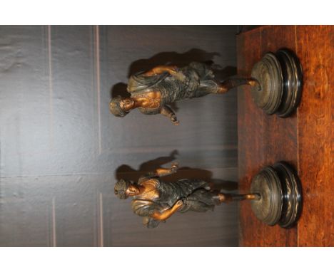 PAIR OF CONTINENTAL SPELTER FIGURES IN BERGMAN-STYLEmodelled as an Oriental male and female figure in active hunting poses, e