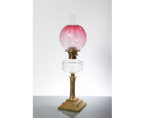 VICTORIAN BRASS OIL LAMP WITH CRANBERRY GLASS SHADE 
with clear glass font, on square stepped base, 67cm high 