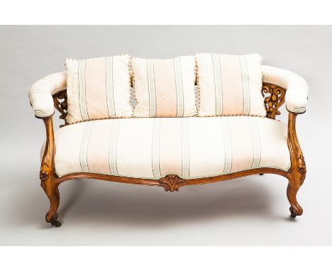 ATTRACTIVE VICTORIAN WALNUT SHAPED BACK SOFA
the open back with three floral and fruit carved scroll splats, upholstered back