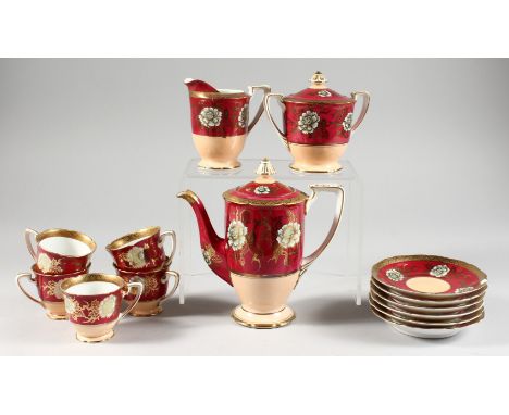 A NORITAKE COFFEE SERVICE, red and pink ground with gilded floral decoration and border, comprising coffee pot, cream jug, su