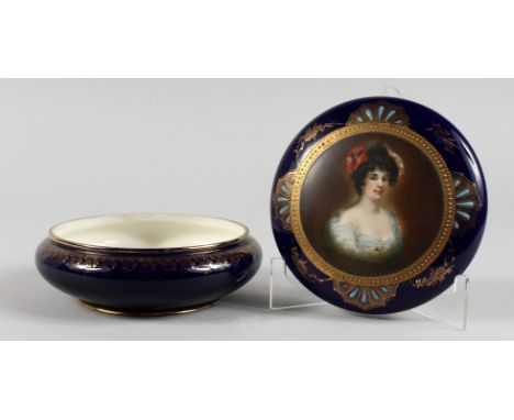 A CONTINENTAL PORCELAIN CIRCULAR BOX AND COVER, rich blue ground with gilded decoration, the cover painted with a portrait bu