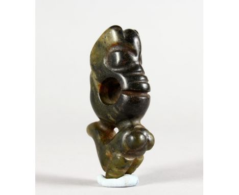 A CARVED JADE AMULET. 2.75ins long.