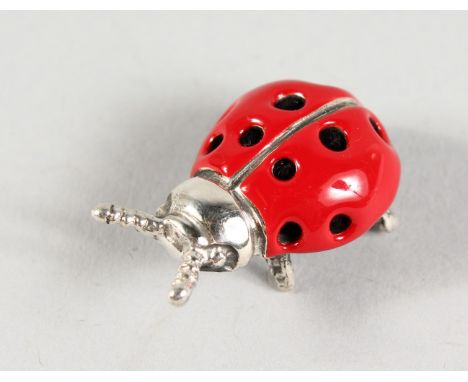 A MINIATURE SILVER AND ENAMEL LADYBIRD. 1ins long.