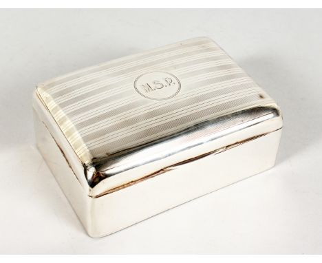 A SILVER CIGARETTE BOX, with engine turned hinged lid. Birmingham 1913.  5ins wide.