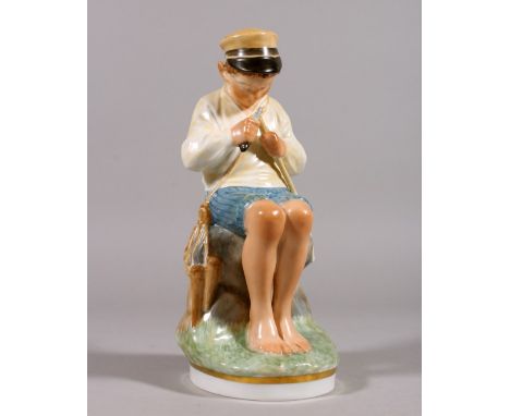 A COPENHAGEN PORCELAIN FIGURE OF A YOUNG BOY sitting on a rock and cutting a stick. Pattern 905.  7.5ins high.