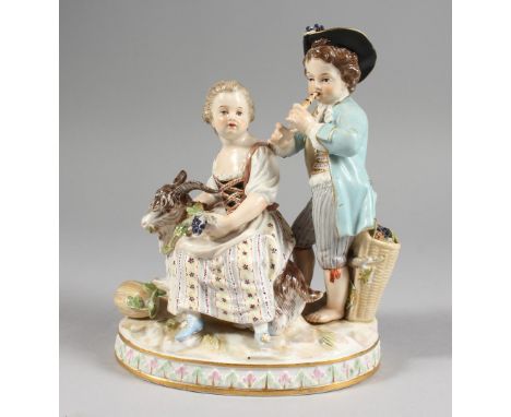 A GOOD MEISSEN PORCELAIN GROUP OF A YOUNG BOY AND GIRL, the boy playing a pipe, the girl seated with a goat. Cross swords mar